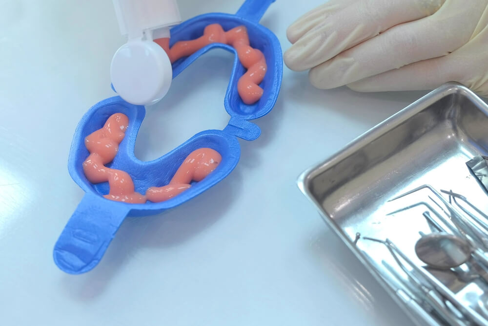 An individual employs a dental tool to create a toothbrush, focusing on the safety aspects of fluoride in dental hygiene.